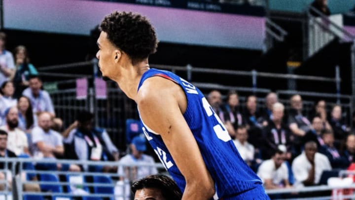 France's Victor Wembanyama (no. 32) and Japan's Yuki Togashi (no. 2) on the court next to each other during a Group B basketball game in Pierre Mauro Stadium at the 2024 Paris Olympics on July 30, 2024. 