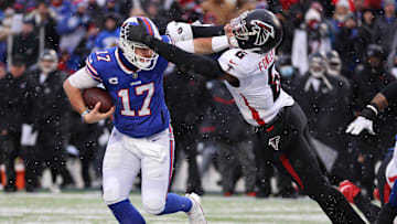 Bills quarterback Josh Allen fights off a tackle by Falcons Donte Fowler Jr.