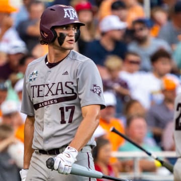 Jun 24, 2024; Omaha, NE, USA; Texas A&M Aggies right fielder Jace Laviolette (17) walks off as catcher Jackson Appel (20) walks up to bat during the sixth inning against the Tennessee Volunteers at Charles Schwab Field Omaha. 