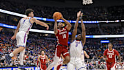 Mar 15, 2025; Nashville, TN, USA;  Alabama Crimson Tide forward Mouhamed Dioubate (10) shoots between Florida Gators guard Walter Clayton Jr. (1) and center Rueben Chinyelu (9) during the first half at Bridgestone Arena.
