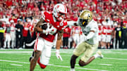 Sep 7, 2024; Lincoln, Nebraska, USA; Nebraska Cornhuskers wide receiver Isaiah Garcia-Castaneda (13) returns a punt against Colorado Buffaloes cornerback Colton Hood (3) during the third quarter at Memorial Stadium. Mandatory Credit: Dylan Widger-Imagn Images