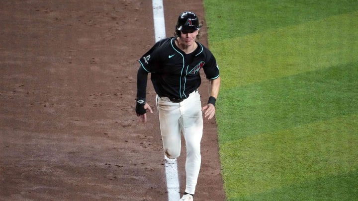 Jul 27, 2024; Phoenix, Arizona, USA; Arizona Diamondbacks outfielder Jake McCarthy (31) scores a run against the Pittsburgh Pirates during the fifth inning at Chase Field. Mandatory Credit: Joe Camporeale-USA TODAY Sports