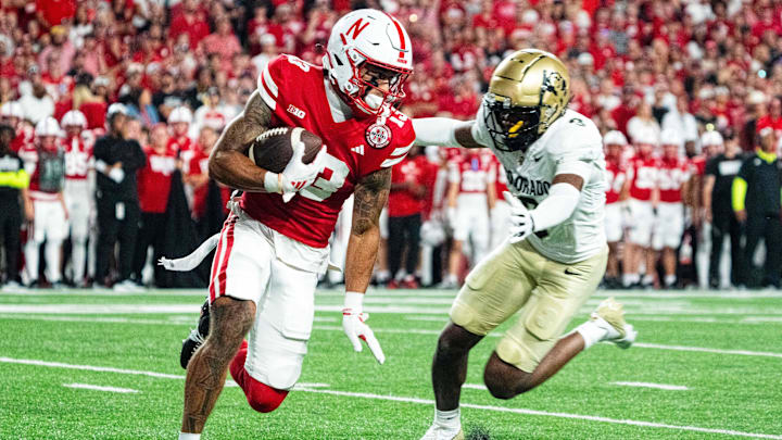 Sep 7, 2024; Lincoln, Nebraska, USA; Nebraska Cornhuskers wide receiver Isaiah Garcia-Castaneda (13) returns a punt against Colorado Buffaloes cornerback Colton Hood (3) during the third quarter at Memorial Stadium.