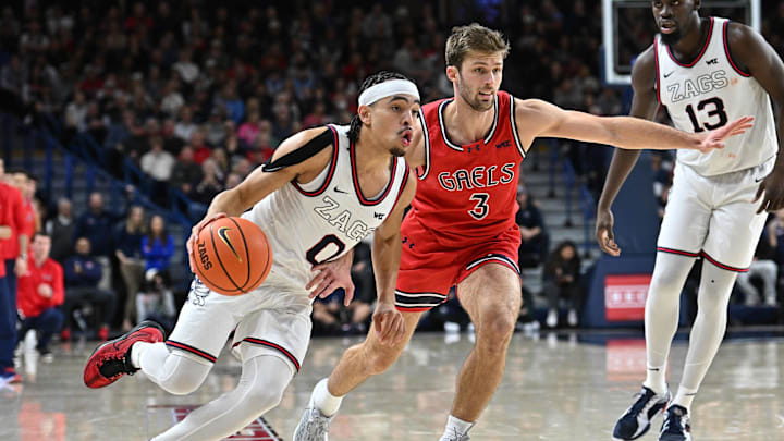 Feb 22, 2025; Spokane, Washington, USA; Gonzaga Bulldogs guard Ryan Nembhard (0) runs the lane abasing St. Mary's Gaels guard Augustas Marciulionis (3) in the second half at McCarthey Athletic Center. Mandatory Credit: James Snook-Imagn Images