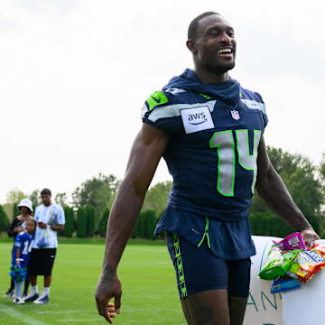 Jul 27, 2024; Renton, WA, USA; Seattle Seahawks wide receiver DK Metcalf (14) walks off the field after training camp at Virginia Mason Athletic Center. Mandatory Credit: Steven Bisig-Imagn Images