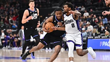Feb 26, 2025; Salt Lake City, Utah, USA;  Utah Jazz guard Isaiah Collier (13) attempts to drive around Sacramento Kings guard Malik Monk (0) in the second half at Delta Center. Mandatory Credit: Jamie Sabau-Imagn Images