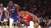 Oct 24, 2025; Houston, Texas, USA; Houston Rockets guard Amen Thompson (1) attempts to control the ball as Detroit Pistons center Jalen Duren (0) defends during the first quarter at Toyota Center. Mandatory Credit: Troy Taormina-Imagn Images