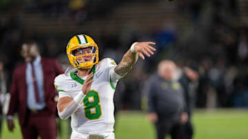 Oct 18, 2024; West Lafayette, Indiana, USA; Oregon Ducks quarterback Dillon Gabriel (8) throws a pass to warm up before the game against the Purdue Boilermakers at Ross-Ade Stadium. Mandatory Credit: Marc Lebryk-Imagn Images