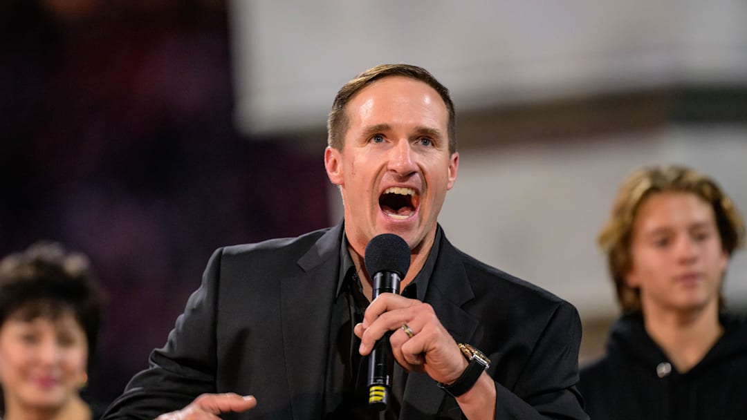 Oct 17, 2024; New Orleans, Louisiana, USA; New Orleans Saints retired quarterback Drew Brees (9) reacts during his hall of fame ceremony at halftime against the Denver Broncos at Caesars Superdome. Mandatory Credit: Matthew Hinton-Imagn Images