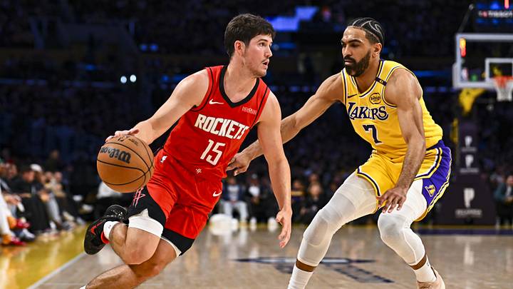 Apr 11, 2025; Los Angeles, California, USA; Houston Rockets guard Reed Sheppard (15) drives the ball against Los Angeles Lakers guard Gabe Vincent (7) during the second half at Crypto.com Arena. Mandatory Credit: Jonathan Hui-Imagn Images