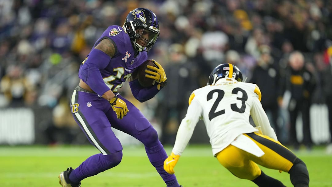 Dec 21, 2024; Baltimore, Maryland, USA; Baltimore Ravens running back Derrick Henry (22) is defended by Pittsburgh Steelers safety Damontae Kazee (23) in the first quarter at M&T Bank Stadium.