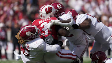 Sep 14, 2024; Madison, Wisconsin, USA;  Wisconsin Badgers running back Tawee Walker (3) is tackled by Alabama Crimson Tide defensive lineman Tim Keenan III (96) during the second quarter at Camp Randall Stadium. Mandatory Credit: Jeff Hanisch-Imagn Images