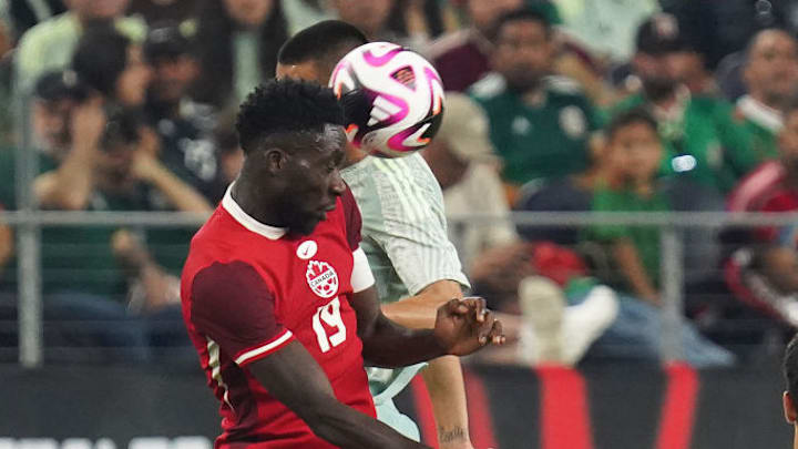 Alphonso Davies #19 of Canada jumps to the header  during...