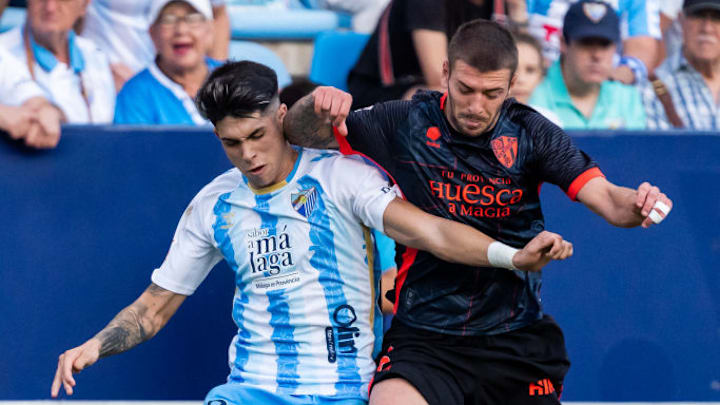 Antonio Cordero (L), of Malaga CF and Oscar Sielva (R), of...