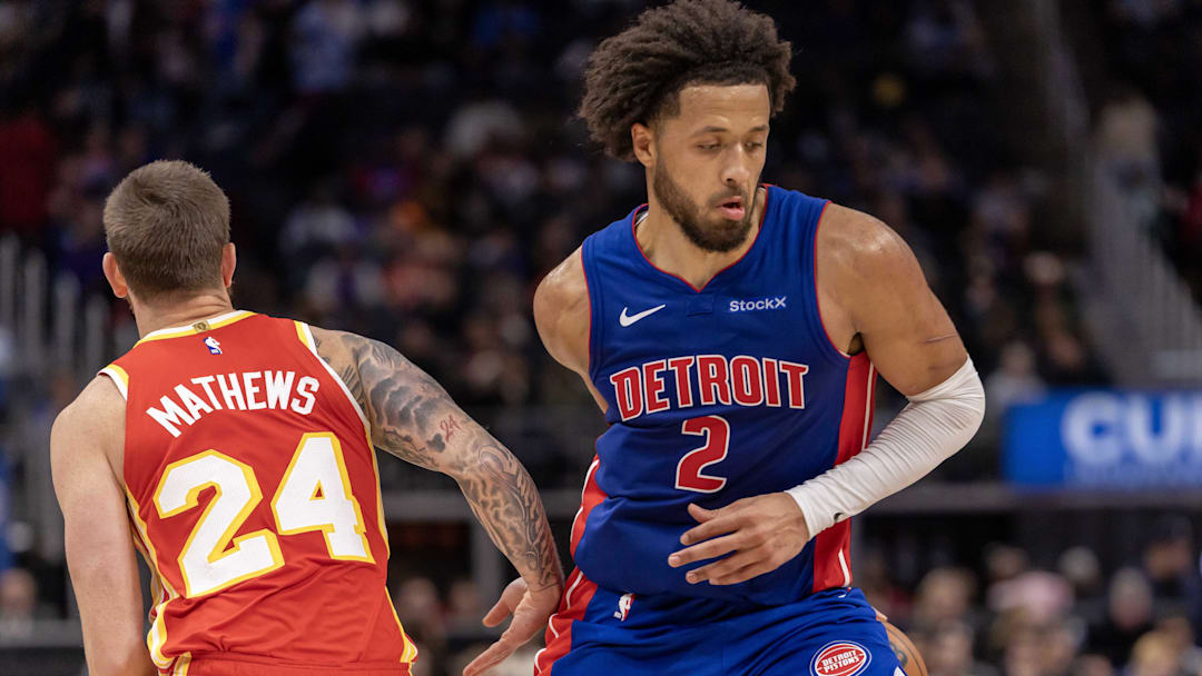 Nov 8, 2024; Detroit, Michigan, USA; Detroit Pistons guard Cade Cunningham (2) makes a behind the back move to avoid the pressure from Atlanta Hawks guard Garrison Mathews (24) during the second half at Little Caesars Arena. Mandatory Credit: David Reginek-Imagn Images