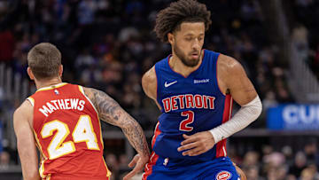 Nov 8, 2024; Detroit, Michigan, USA; Detroit Pistons guard Cade Cunningham (2) makes a behind the back move to avoid the pressure from Atlanta Hawks guard Garrison Mathews (24) during the second half at Little Caesars Arena. Mandatory Credit: David Reginek-Imagn Images
