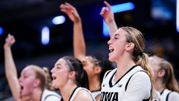Iowa Hawkeyes guard Lucy Olsen (33) and her team celebrate Wednesday, March 5, 2025, in a round one game at the 2025 TIAA Big Ten Women's Basketball Tournament between the Iowa Hawkeyes and the Wisconsin Badgers at Gainbridge Fieldhouse in Indianapolis.
