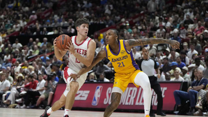 Jul 12, 2024; Las Vegas, NV, USA;  Houston Rockets guard Reed Sheppard (15) drives the ball against Los Angeles Lakers forward Maxwell Lewis (21) during the first half at the Thomas & Mack Center. Mandatory Credit: Lucas Peltier-USA TODAY Sports