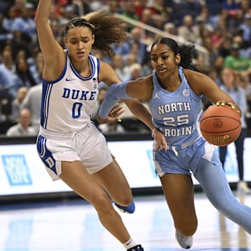 Mar 3, 2023; Greensboro, NC, USA; North Carolina Tar Heels guard Deja Kelly (25) drives against Duke Blue Devils guard Celeste Taylor (0) during the first half at Greensboro Coliseum. Mandatory Credit: William Howard-Imagn Images