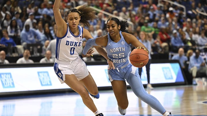 Mar 3, 2023; Greensboro, NC, USA; North Carolina Tar Heels guard Deja Kelly (25) drives against Duke Blue Devils guard Celeste Taylor (0) during the first half at Greensboro Coliseum. Mandatory Credit: William Howard-Imagn Images