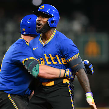 Seattle Mariners left fielder Luke Raley (left) and designated hitter Randy Arozarena (right) celebrate after Arozarena's walk off single against the Texas Rangers on Saturday at T-Mobile Park.