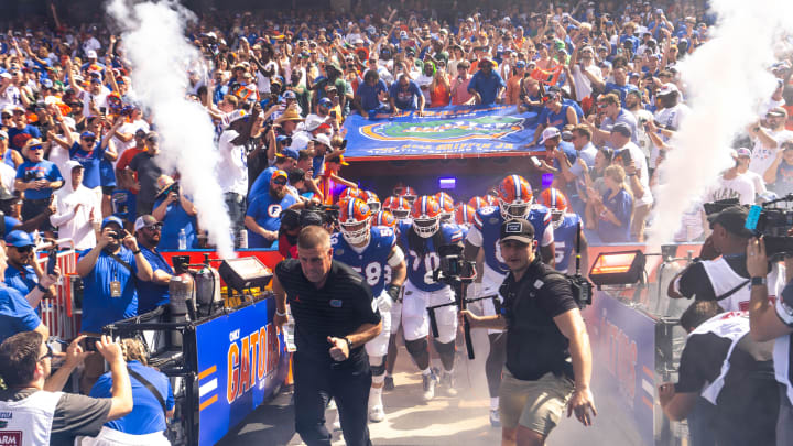 Florida Gators head coach Billy Napier runs out of the tunnel with his team during the season opener at Ben Hill Griffin Stadium in Gainesville, FL on Saturday, August 31, 2024 against the University of Miami Hurricanes. The Hurricanes defeated the Gators 41-17. [Doug Engle/Gainesville Sun]