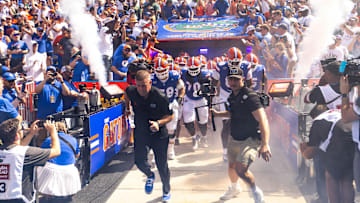 Florida Gators head coach Billy Napier runs out of the tunnel with his team during the season opener at Ben Hill Griffin Stadium in Gainesville, FL on Saturday, August 31, 2024 against the University of Miami Hurricanes. The Hurricanes defeated the Gators 41-17. [Doug Engle/Gainesville Sun]