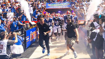 Florida Gators head coach Billy Napier runs out of the tunnel with his team during the season opener at Ben Hill Griffin Stadium in Gainesville, FL on Saturday, August 31, 2024 against the University of Miami Hurricanes. The Hurricanes defeated the Gators 41-17. [Doug Engle/Gainesville Sun]