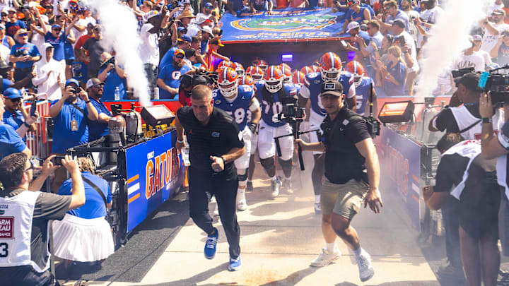 Florida Gators head coach Billy Napier runs out of the tunnel with his team during the season opener at Ben Hill Griffin Stadium in Gainesville, FL on Saturday, August 31, 2024 against the University of Miami Hurricanes. The Hurricanes defeated the Gators 41-17. [Doug Engle/Gainesville Sun]