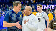Cal coach Mark Madsen, left, visits with Notre Dame coach Micah Shrewsberry after the Irish beat the Bears 112-110 in four overtimes.  