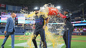 May 2, 2025; Toronto, Ontario, CAN; Toronto Blue Jays first base Vladimir Guerrero Jr. (27) pours the ice bucket on  pinch hitter and centre fielder Nathan Lukes (38) against the Cleveland Guardians at the end of the ninth inning at Rogers Centre. Mandatory Credit: Nick Turchiaro-Imagn Images