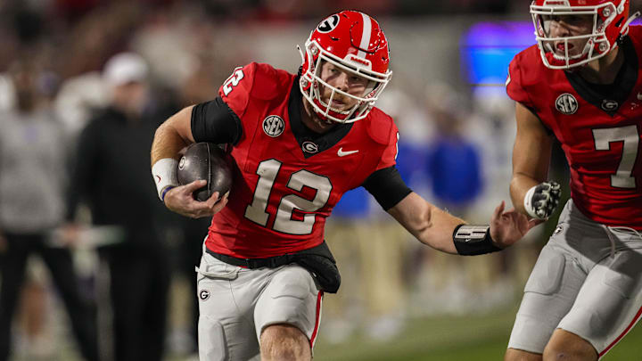 Oct 7, 2023; Athens, Georgia, USA; Georgia Bulldogs quarterback Brock Vandagriff (12) runs against the Kentucky Wildcats during the second half at Sanford Stadium. Mandatory Credit: Dale Zanine-Imagn Images