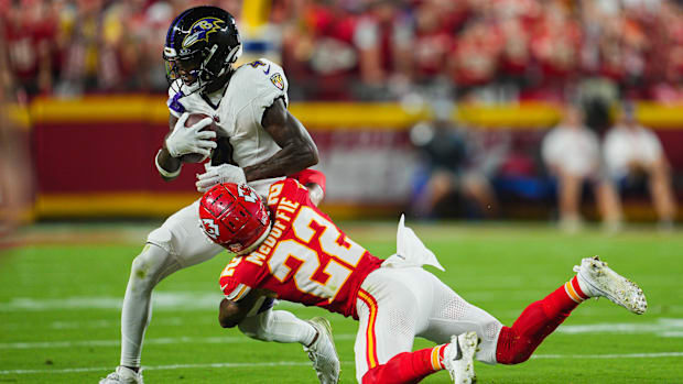 Baltimore Ravens wide receiver Zay Flowers is tackled by Kansas City Chiefs cornerback Trent McDuffie.