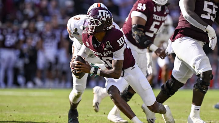 Dec 20, 2025; College Station, TX, USA; Texas A&M Aggies quarterback Marcel Reed (10) eludes the tackle of Miami Hurricanes defensive lineman Akheem Mesidor (3) during the game between the Aggies and the Hurricanes at Kyle Field. Mandatory Credit: Jerome Miron-Imagn Images