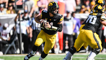 Sep 27, 2025; Iowa City, Iowa, USA; Iowa Hawkeyes quarterback Mark Gronowski (11) rolls out to throw a pass against the Indiana Hoosiers during the first quarter at Kinnick Stadium. Mandatory Credit: Jeffrey Becker-Imagn Images