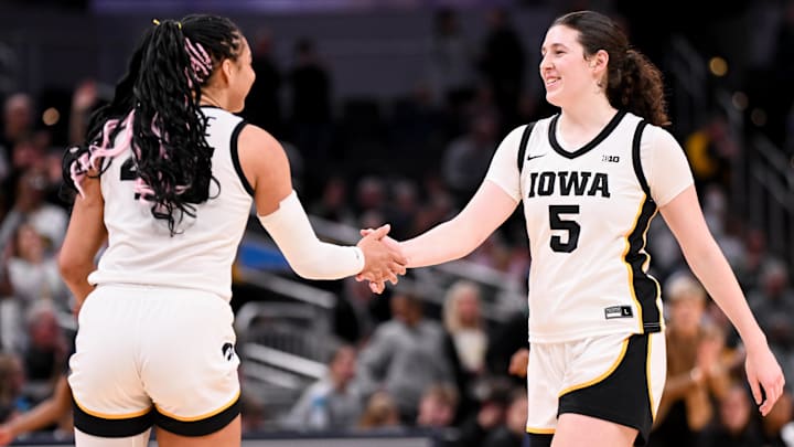 Mar 7, 2026; Indianapolis, IN, USA; Iowa Hawkeyes forward Hannah Stuelke (45) and Iowa Hawkeyes center Ava Heiden (5) high-five against the Michigan Wolverines during the second half at Gainbridge Fieldhouse. Mandatory Credit: Robert Goddin-Imagn Images