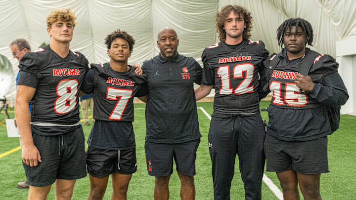 Players from St. Thomas Aquinas High School's Trojans at the first media day of the upcoming season. From left to right: Christian Magliacano, Elijah Abass-Shereef, Team Coach Tarig Holman, Jack Joyce, and Davon Grant. Players from St. Thomas Aquinas High School's Trojans at the first media day of the upcoming season. From left to right: Christian Magliacano, Elijah Abass-Shereef, Team Coach Tarig Holman, Jack Joyce, and Davon Grant.
