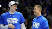 Mar 15, 2025; Charlotte, NC, USA; Duke Blue Devils forward Cooper Flagg (2) and head coach Jon Scheyer celebrate after winning the 2025 ACC Conference Championship game against the Louisville Cardinals at Spectrum Center. Mandatory Credit: Bob Donnan-Imagn Images