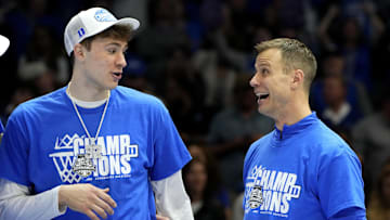 Mar 15, 2025; Charlotte, NC, USA; Duke Blue Devils forward Cooper Flagg (2) and head coach Jon Scheyer celebrate after winning the 2025 ACC Conference Championship game against the Louisville Cardinals at Spectrum Center. Mandatory Credit: Bob Donnan-Imagn Images