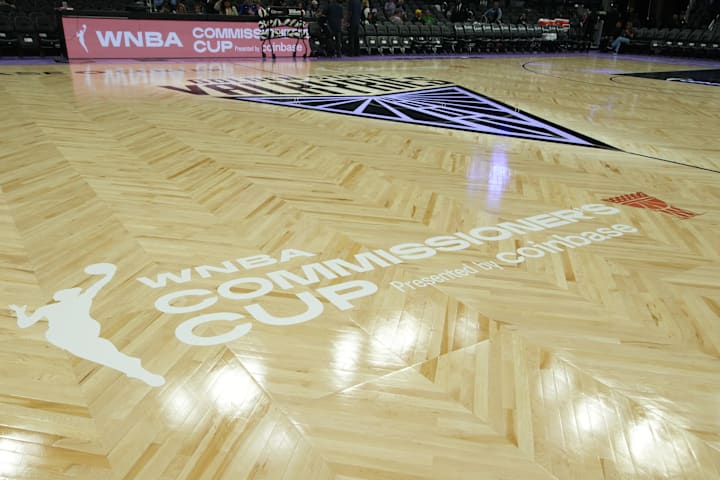 WNBA Commissioner's Cup logo on the court. 