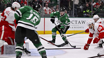 Jan 19, 2025; Dallas, Texas, USA; Dallas Stars center Colin Blackwell (15) passes the puck to right wing Matej Blumel (25) during the second period against the Detroit Red Wings at the American Airlines Center. Mandatory Credit: Jerome Miron-Imagn Images