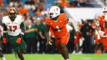 Sep 7, 2024; Miami Gardens, Florida, USA; Miami Hurricanes quarterback Cam Ward (1) runs with the football against the Florida A&M Rattlers during the third quarter at Hard Rock Stadium. Mandatory Credit: Sam Navarro-Imagn Images