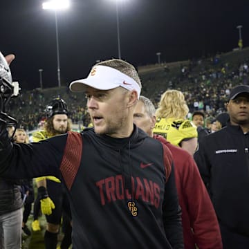 Nov 11, 2023; Eugene, Oregon, USA; USC Trojans head coach Lincoln Riley congratulates Oregon Ducks quarterback Bo Nix (10) after a game at Autzen Stadium. Mandatory Credit: Troy Wayrynen-Imagn Images