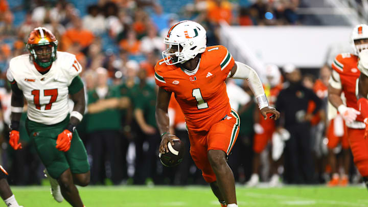 Sep 7, 2024; Miami Gardens, Florida, USA; Miami Hurricanes quarterback Cam Ward (1) runs with the football against the Florida A&M Rattlers during the third quarter at Hard Rock Stadium. Mandatory Credit: Sam Navarro-Imagn Images