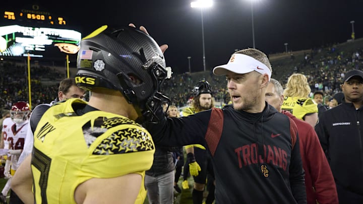Nov 11, 2023; Eugene, Oregon, USA; USC Trojans head coach Lincoln Riley congratulates Oregon Ducks quarterback Bo Nix (10) after a game at Autzen Stadium. Mandatory Credit: Troy Wayrynen-Imagn Images