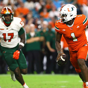 Sep 7, 2024; Miami Gardens, Florida, USA; Miami Hurricanes quarterback Cam Ward (1) runs with the football against the Florida A&M Rattlers during the third quarter at Hard Rock Stadium. Mandatory Credit: Sam Navarro-Imagn Images