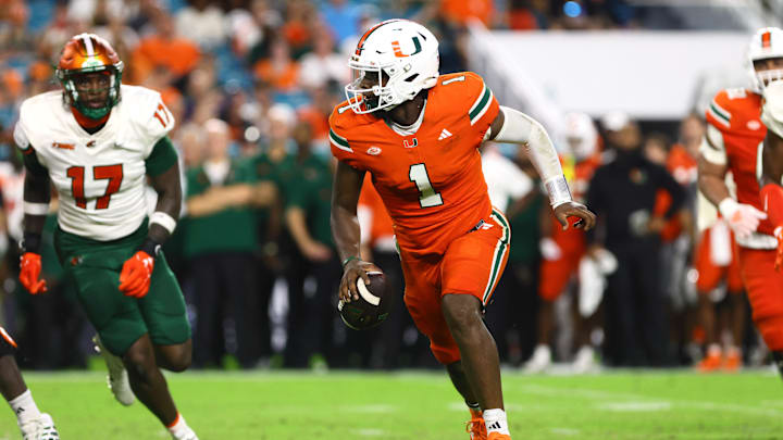 Sep 7, 2024; Miami Gardens, Florida, USA; Miami Hurricanes quarterback Cam Ward (1) runs with the football against the Florida A&M Rattlers during the third quarter at Hard Rock Stadium. Mandatory Credit: Sam Navarro-Imagn Images