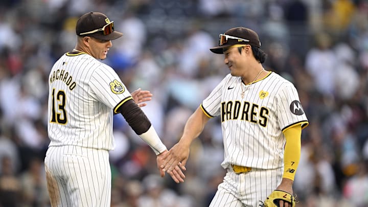 Jul 13, 2024; San Diego, California, USA; San Diego Padres designated hitter Manny Machado (13) and shortstop Ha-Seong Kim (7) celebrate on the field after defeating the Atlanta Braves at Petco Park. Mandatory Credit: Orlando Ramirez-Imagn Images 