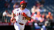 Sep 28, 2025; Anaheim, California, USA; Los Angeles Angels left fielder Chris Taylor (33) runs after hitting a single during the ninth inning against the Houston Astros at Angel Stadium. Mandatory Credit: William Liang-Imagn Images