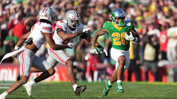 Jan 1, 2025; Pasadena, CA, USA; Oregon Ducks running back Jordan James (20) runs against Ohio State Buckeyes safety Sonny Styles (6) in the first half in the 2025 Rose Bowl college football quarterfinal game at Rose Bowl Stadium.